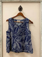 Blue and white patterned tank on a hanger against a neutral background