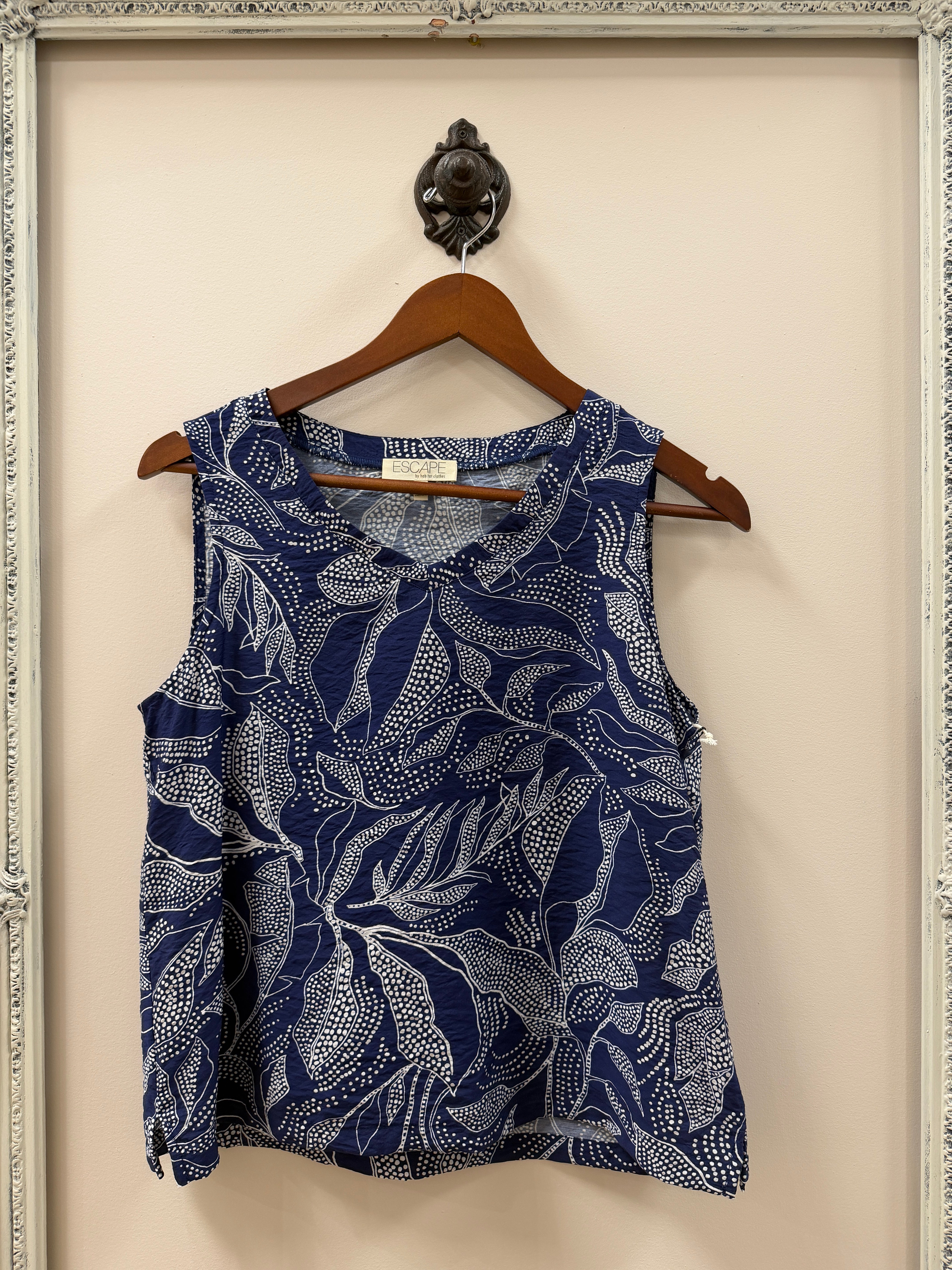 Blue and white patterned tank on a hanger against a neutral background