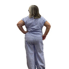 Woman wearing Escape Tie Front Top in Blue with blue and white stripes on white background. 