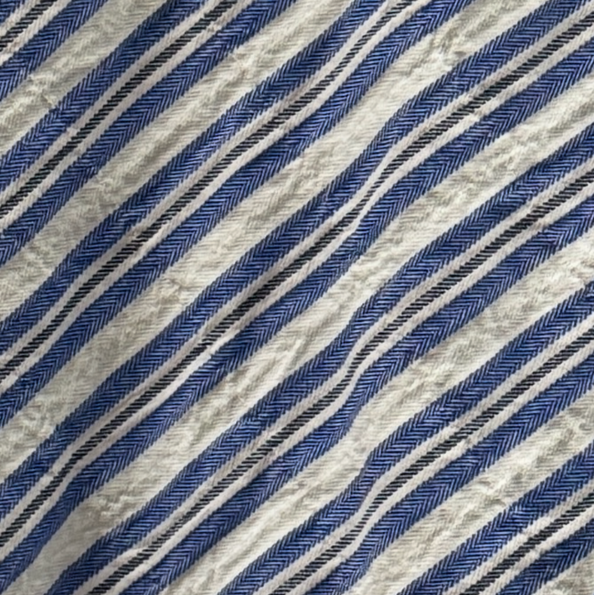 Textured fabric with blue and gray diagonal stripes