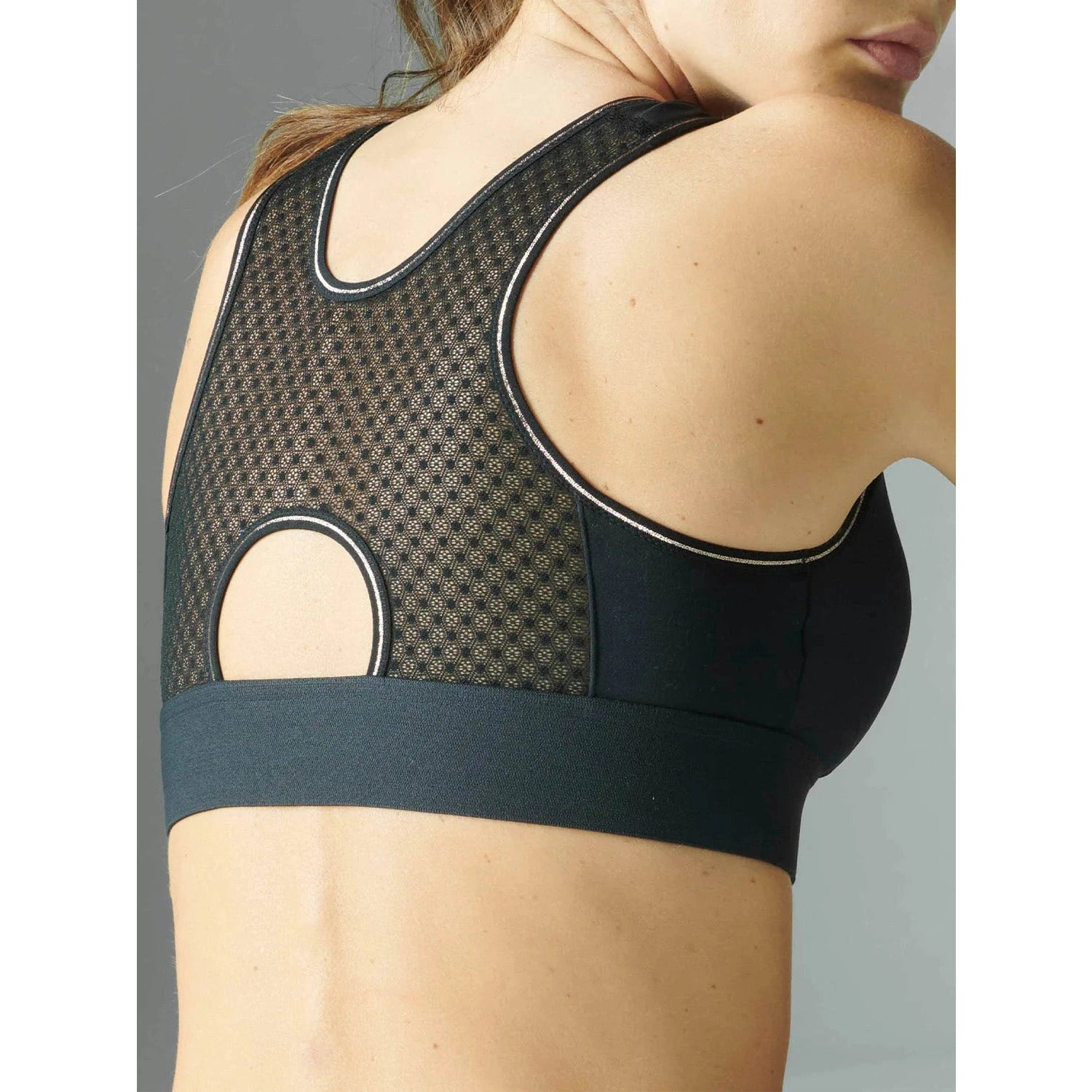 Harmony Wireless Sports Bra in black shown on a model with a view of the back. 