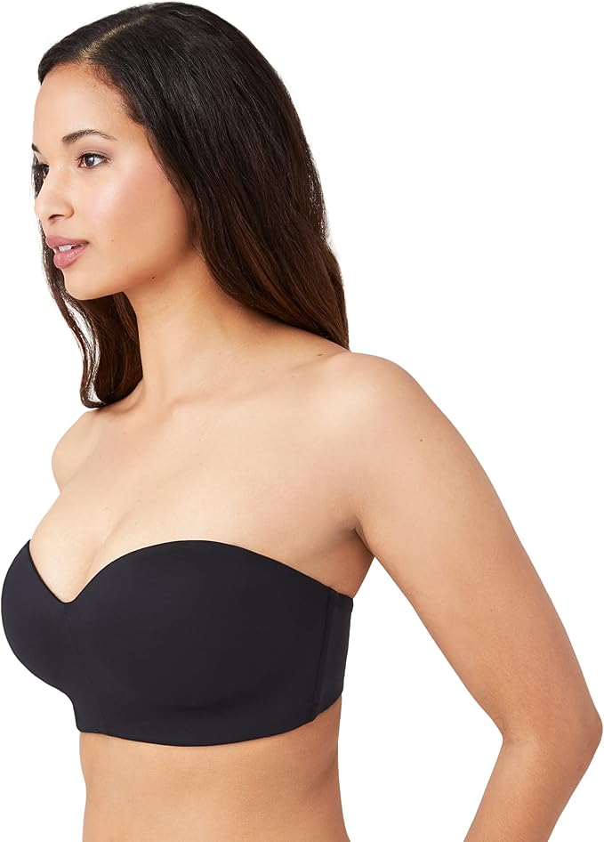 Woman wearing a black Wacoal Red Carpet strapless bra on a white background showing the side angle view. 