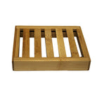 Wooden soap dish with slotted design on a white background